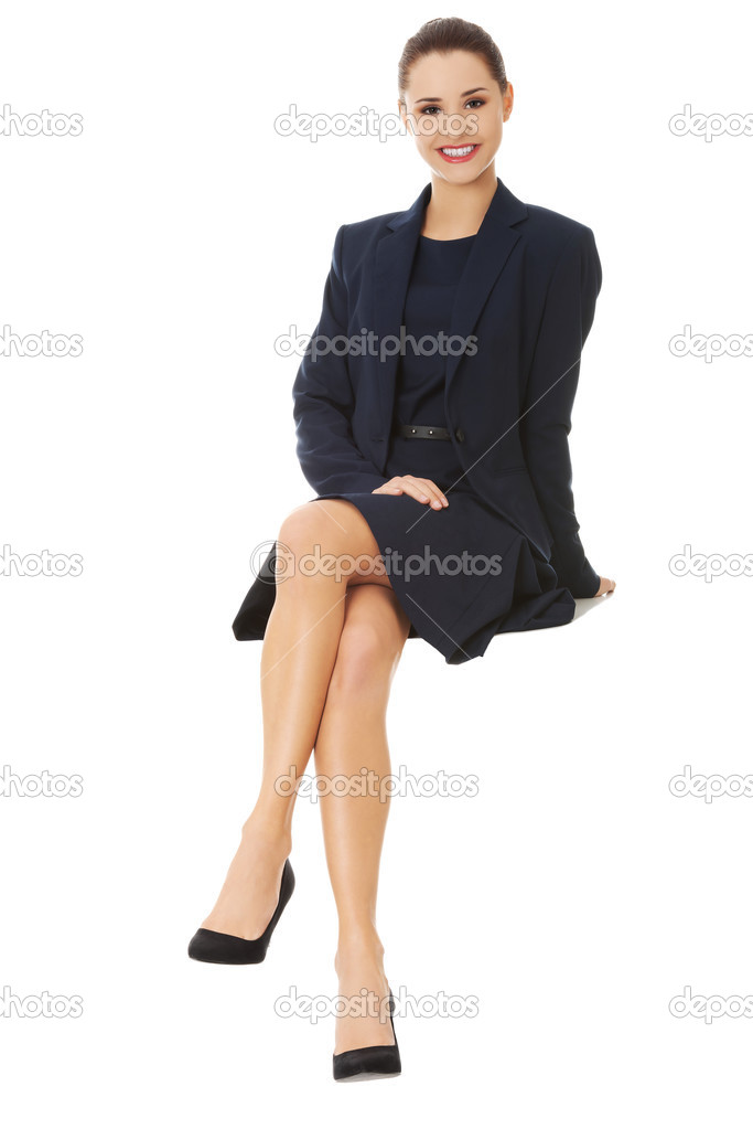 Businesswoman sitting on blank billboard.