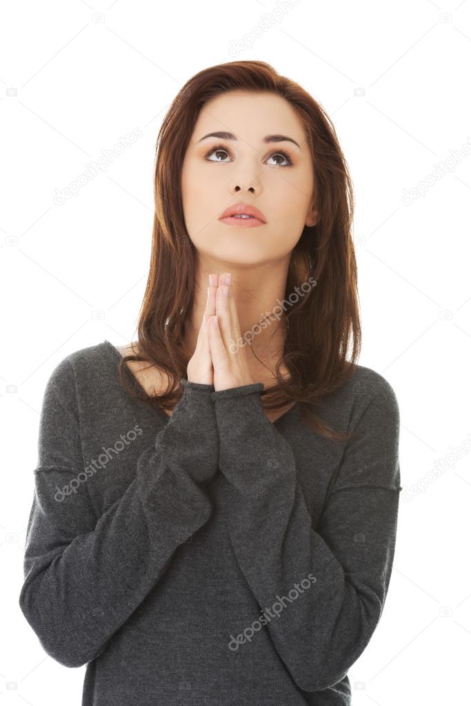 Woman praying with her hands together