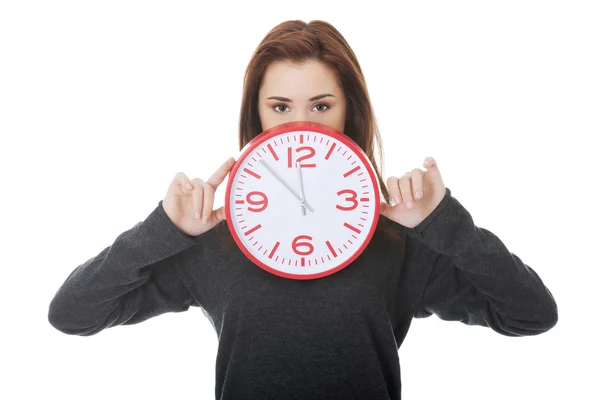 Woman holding office clock — Stock Photo, Image