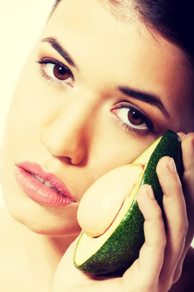 Beautiful woman holding avocado — Stock Photo, Image