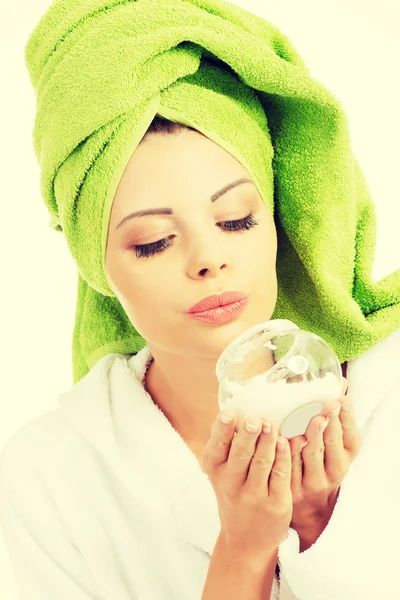 Beautiful woman holding face cream. — Stock Photo, Image