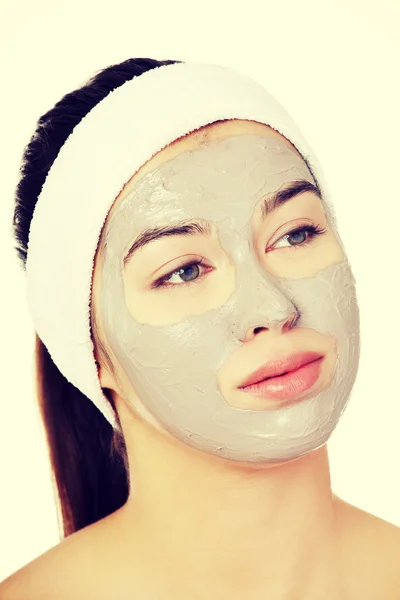 Beautiful woman with clay facial mask — Stock Photo, Image