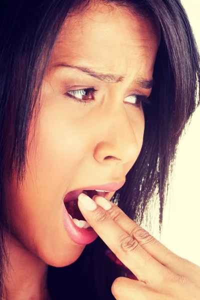 Woman putting her finger in her mouth — Stock Photo, Image