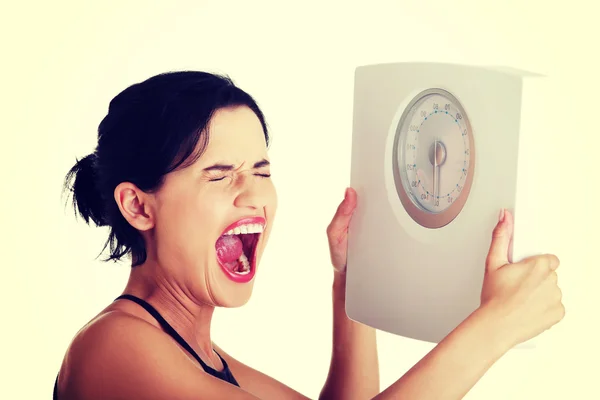 Frustrated woman with scale — Stock Photo, Image