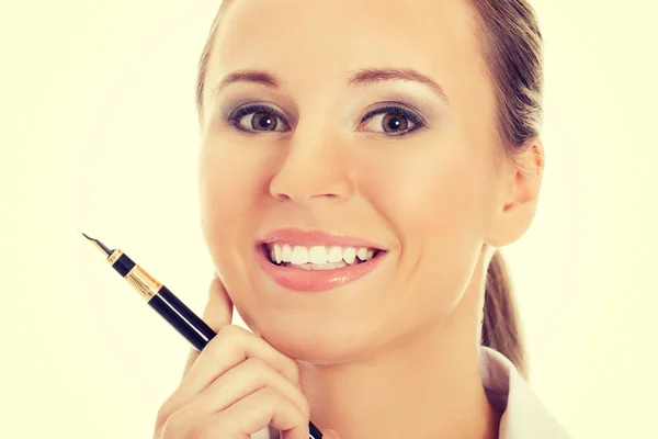 Young business woman holding a pen. — Stock Photo, Image