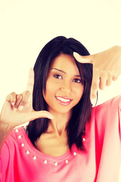 Happy girl with face in frame of palms. — Stock Photo, Image