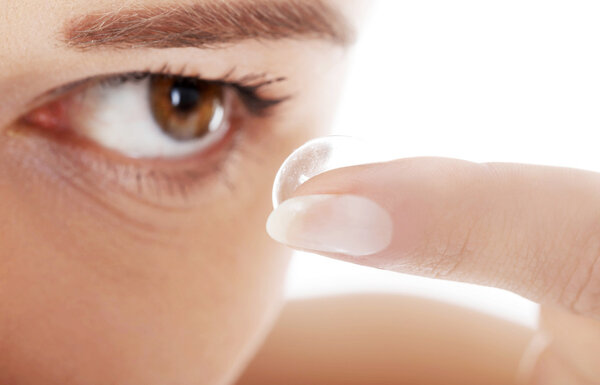 Woman putting contact lens