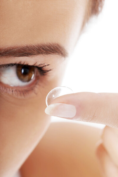 Woman putting contact lens
