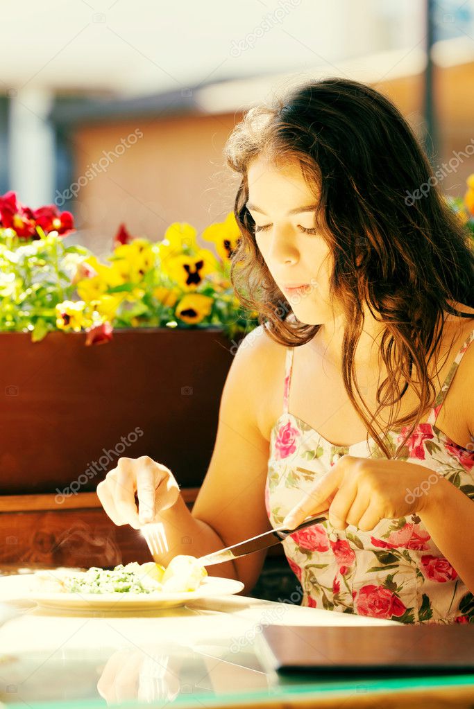 Woman eating dinner.
