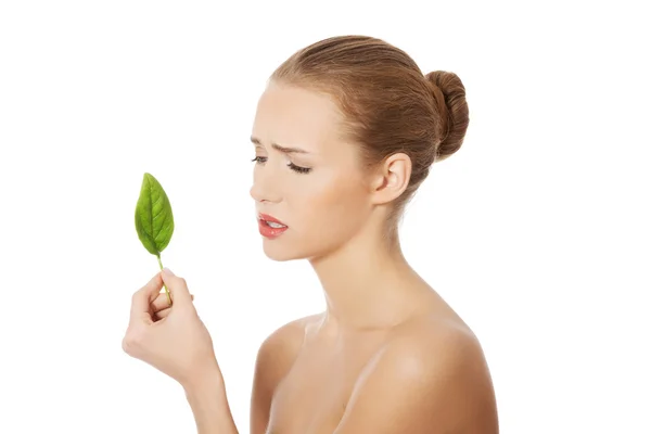 Beautiful woman with one green leaf. — Stock Photo, Image