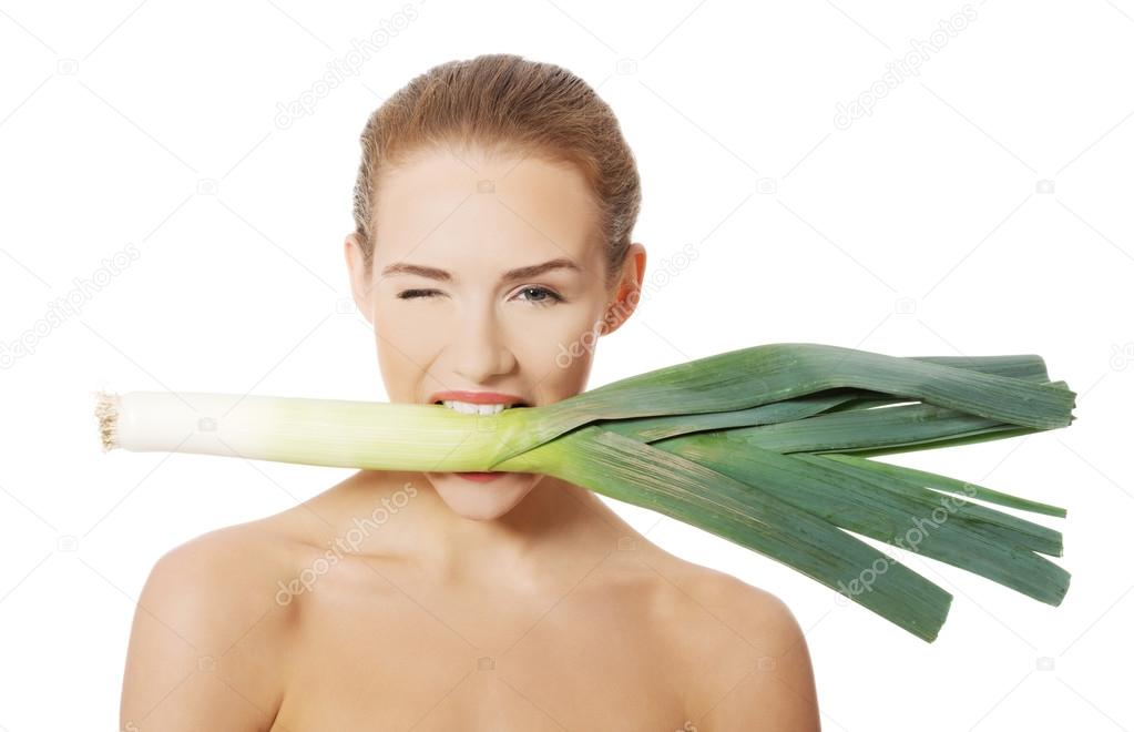 Woman with leek in mouth