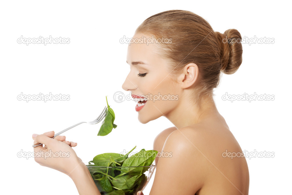 Woman eating lettuce from bowl
