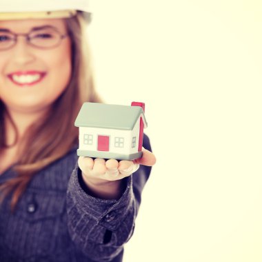 Young beautiful business woman with house model clipart