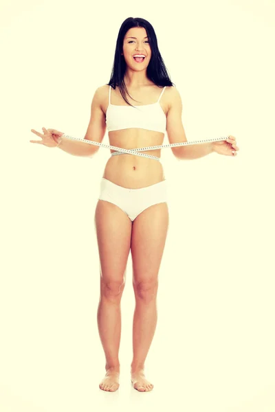 Sexy, mujer joven midiendo su cintura —  Fotos de Stock