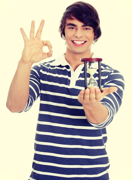 Young man with hourglass. — Stock Photo, Image