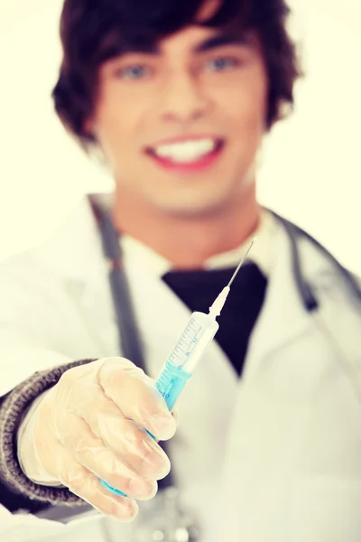 Guapo joven médico sosteniendo la jeringa — Foto de Stock