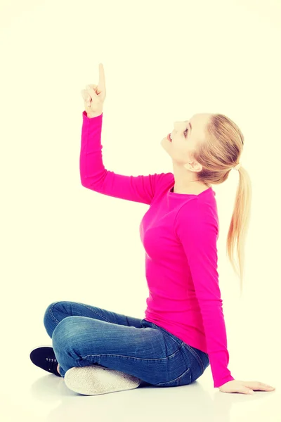 Casual woman pointing up. — Stock Photo, Image