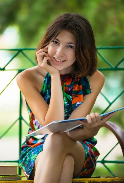 Pretty girl with a book in the park — Stock Photo, Image