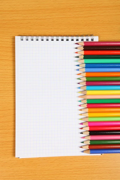 Pencils and checked notebook — Stock Photo, Image