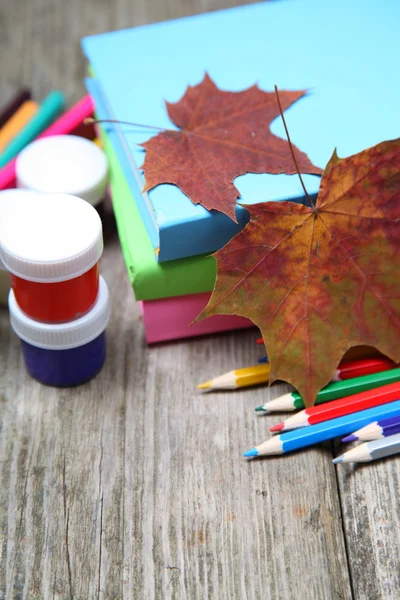 Books, pencils and maple leaf — Stock Photo, Image