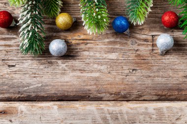 Noel ağacı dalları ve toplar eski ahşap bir arka planda. Noel dekoru. Metnin için yer.