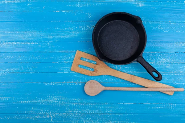 Leere Gusseiserne Pfanne Auf Blauem Holzgrund Holzspachtel Und Küchentuch Platz — Stockfoto