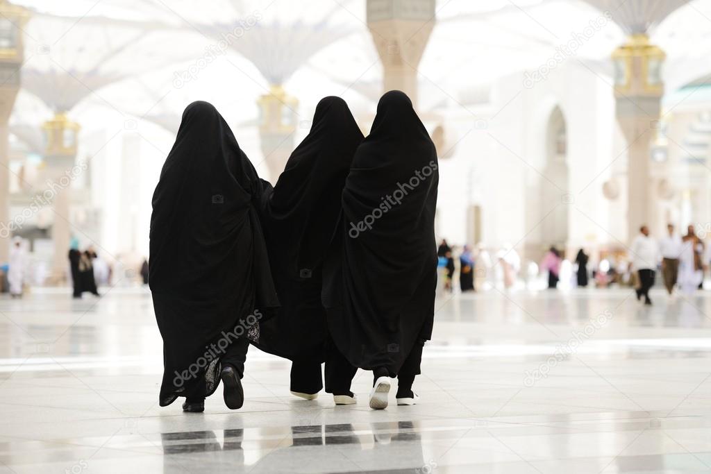 Three Moslim women walking outdoors
