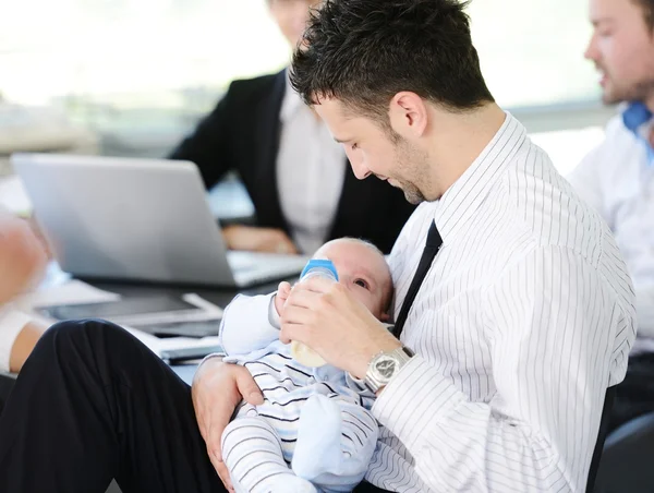 Business taking care of baby in office — Stock Photo, Image