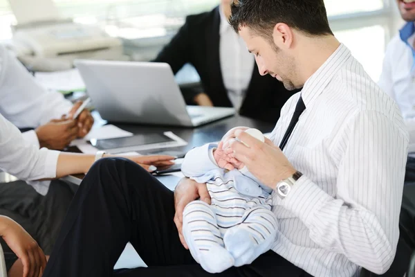 Business taking care of baby in office — Stock Photo, Image