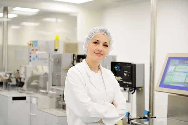 Mulher trabalhadora na linha de produção automatizada na fábrica moderna — Fotografia de Stock