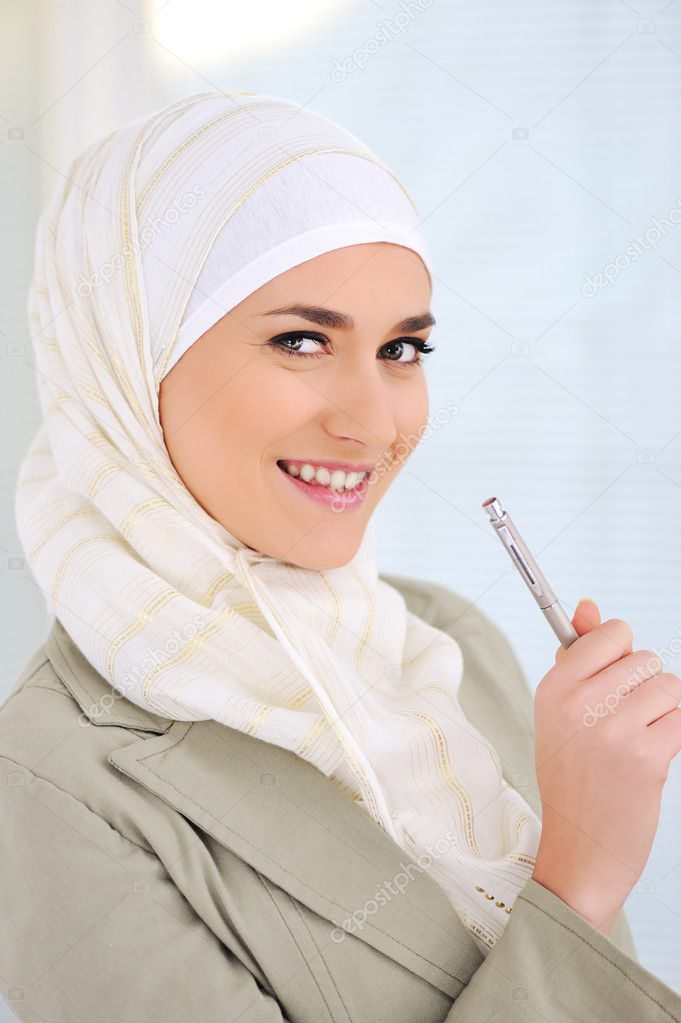 Muslim Caucasian female student holding pen