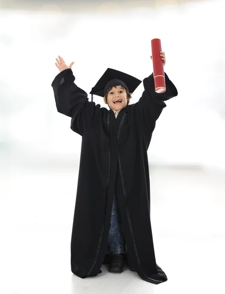 Feliz niño exitoso con diploma y ropa de graduación — Foto de Stock