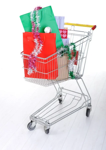 Shopping trolley cart with present boxes and bags — Stock Photo, Image