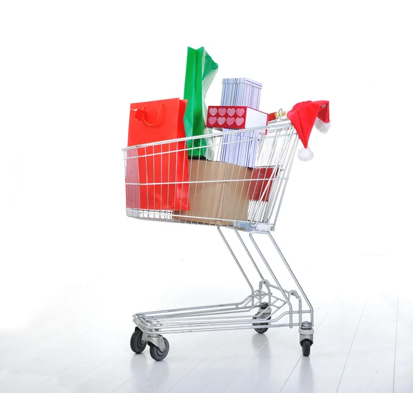 Shopping cart with boxes and bags in — Stock Photo, Image