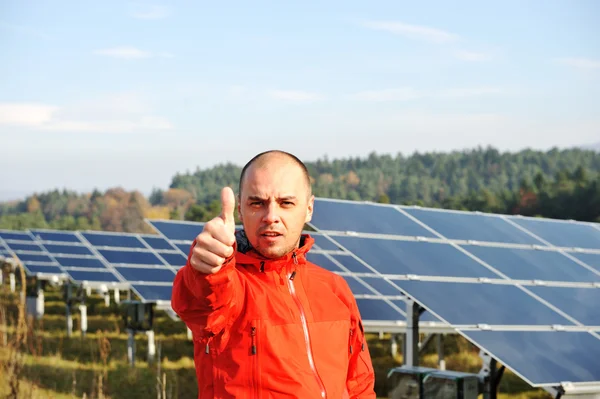 Male worker at solar panel field Stock Photo