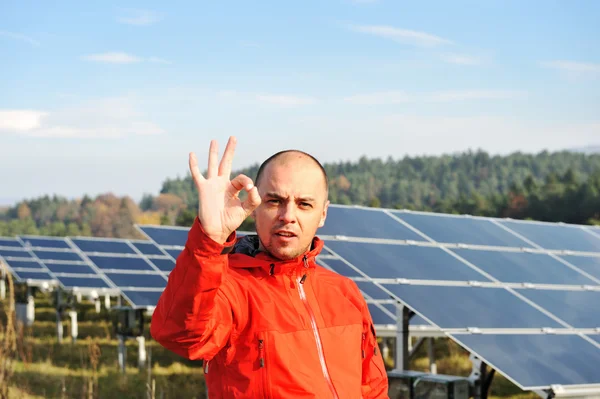 Male worker at solar panel field Stock Photo