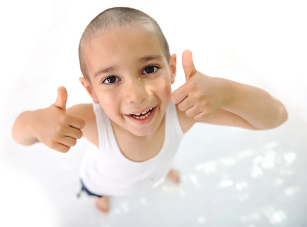 Thumbs up! Little boy, cute short hair, almost bald :) Stock Photo