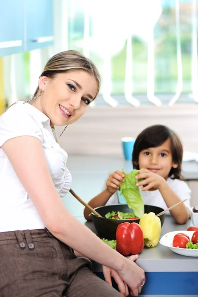 Beautiful mother and little son in kitchen together — Stock Photo, Image