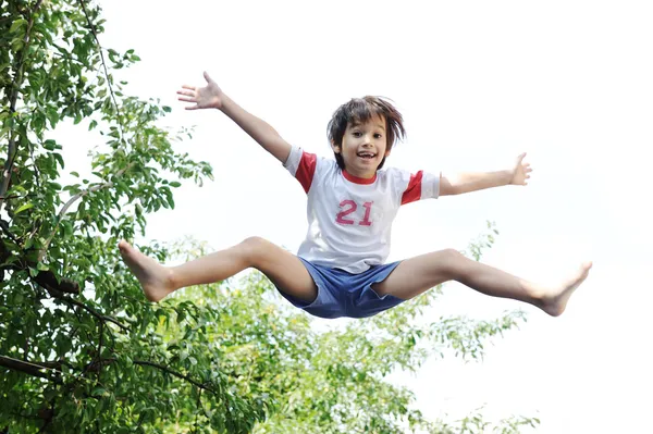 Jumping kid in the air — Stock Photo, Image