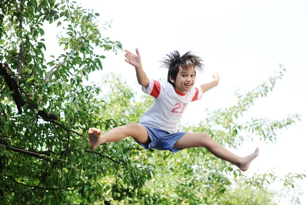 Jumping kid in the air — Stock Photo, Image