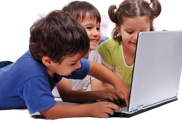 Happy kids with laptop computer isolated Stock Image