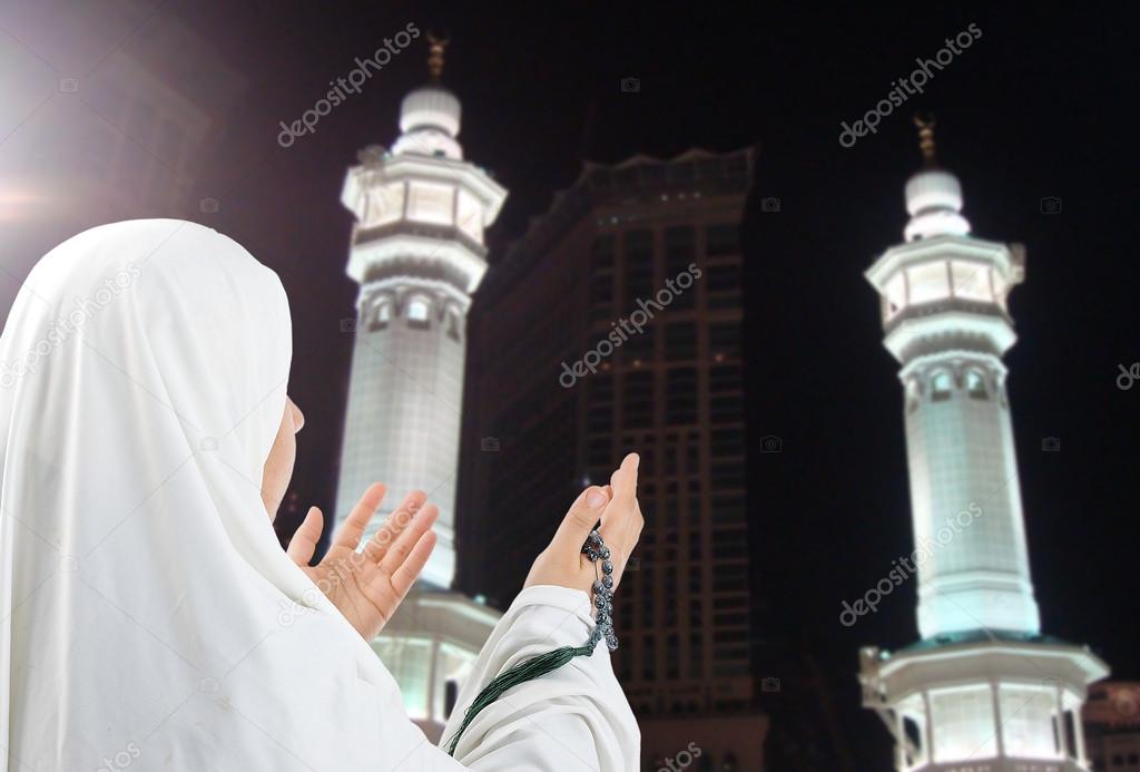 Young woman, muslim pilgrim in white traditional clothes