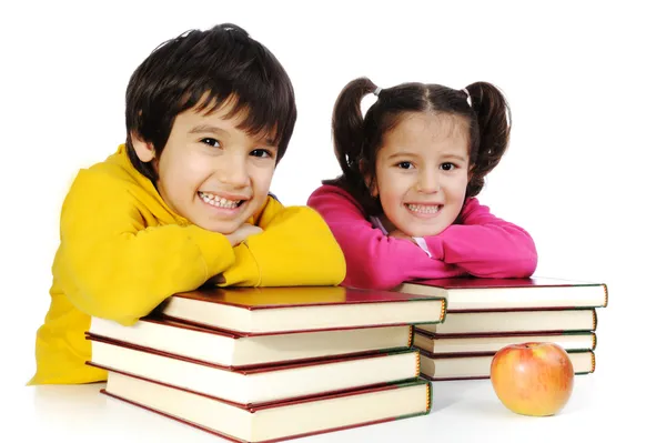 Tow kids learning at the desk with lot of books, — Stock Photo, Image