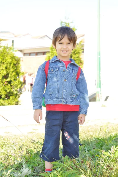 Happy children in front of the school, outdoor, summer to fall — Stock Photo, Image