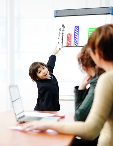 Genius kid on business presentation speaking to adults and giving them a lecture — Stock Photo, Image