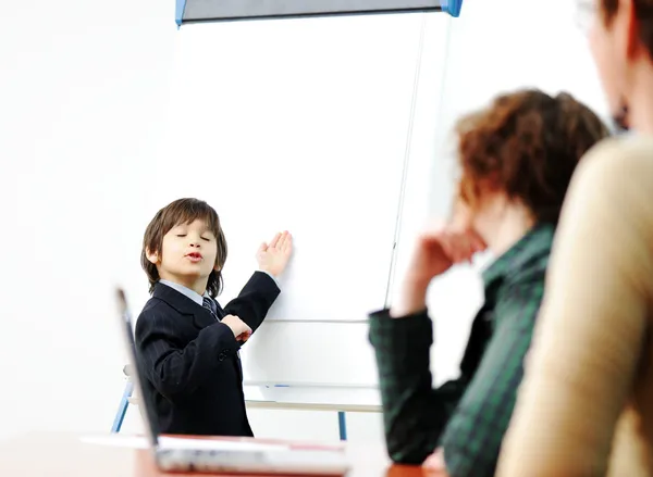 Genius kid on business presentation speaking to adults and giving them a lecture — Stock Photo, Image