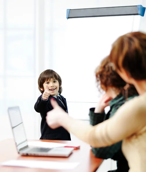 Genius kid on business presentation speaking to adults and giving them a lecture — Stock Photo, Image