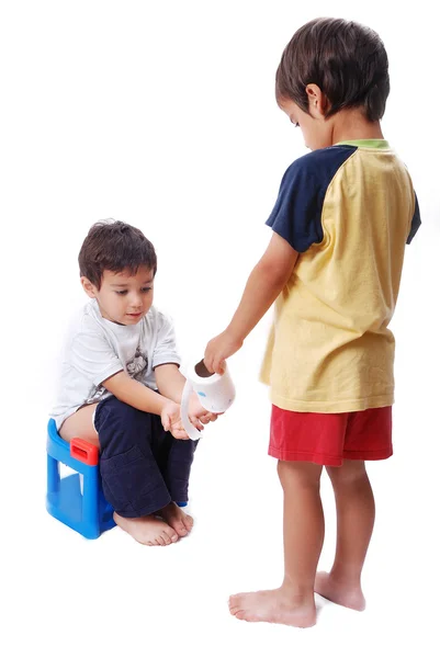 Kid is helping another one on toilet — Stock Photo, Image