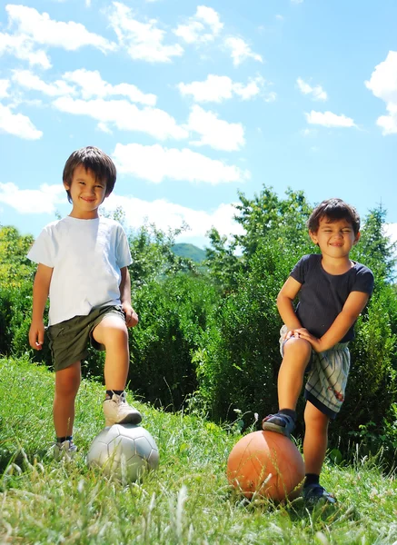 Two little kids with basketball and football — Stock Photo, Image