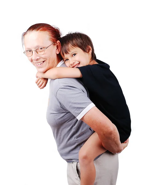 Middle aged woman holding little boy on her back — Stock Photo, Image